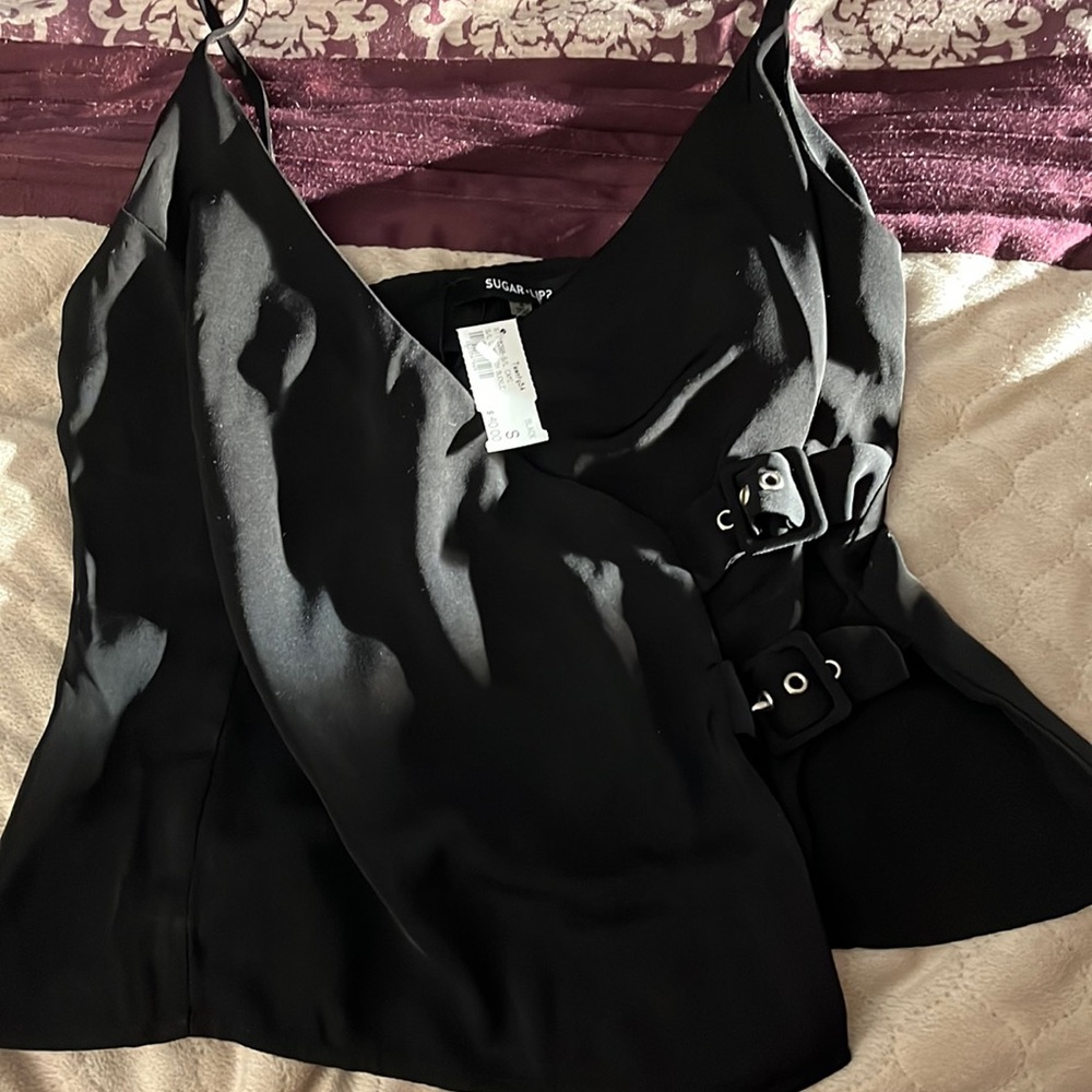 Black dressy tank top size small. Two buckles on side. Never worn. New with tags